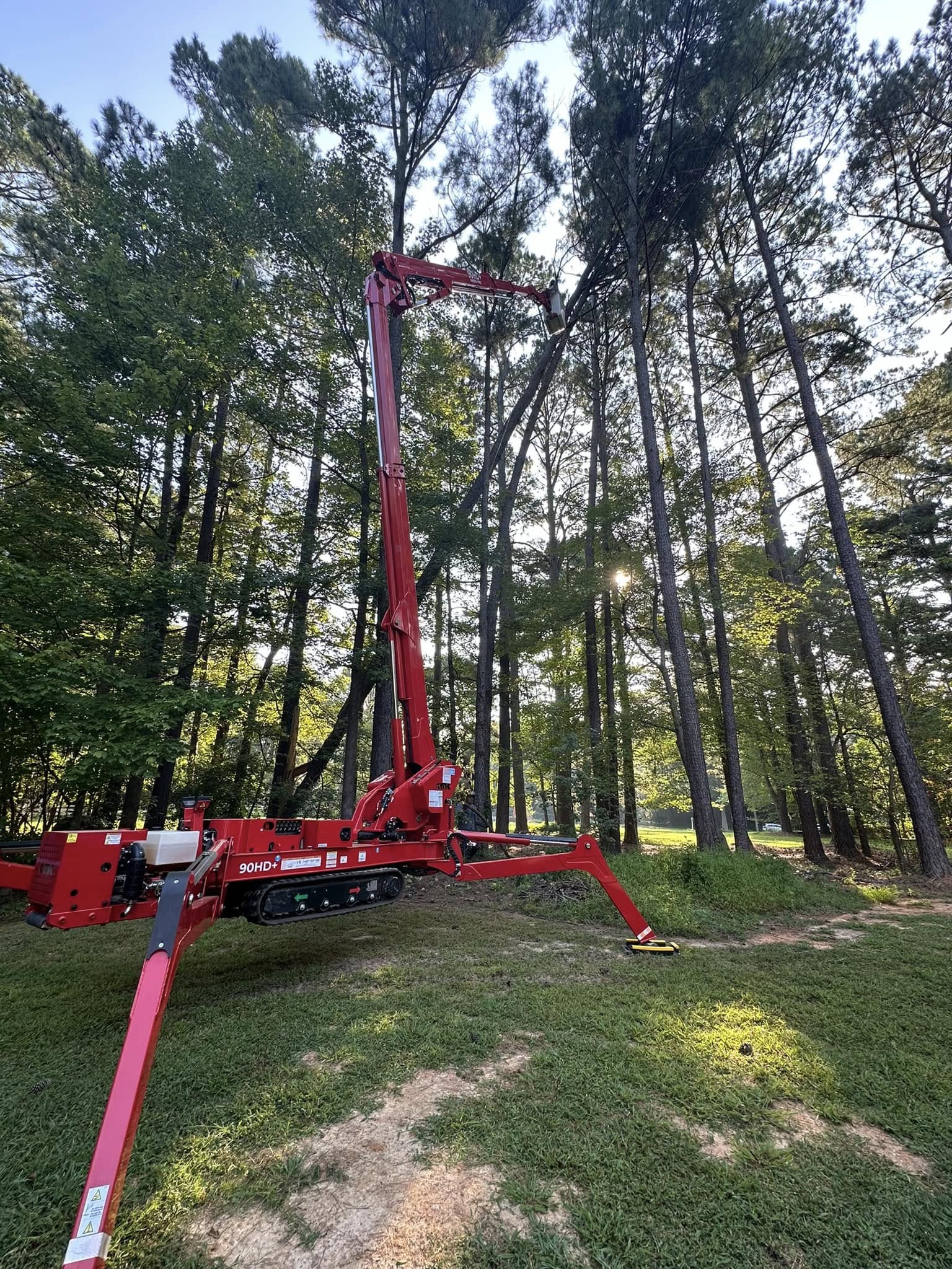 Kenny's Tree Removal advanced 90HD+ compact tracked spider lift machinery operating safely on a residential lawn