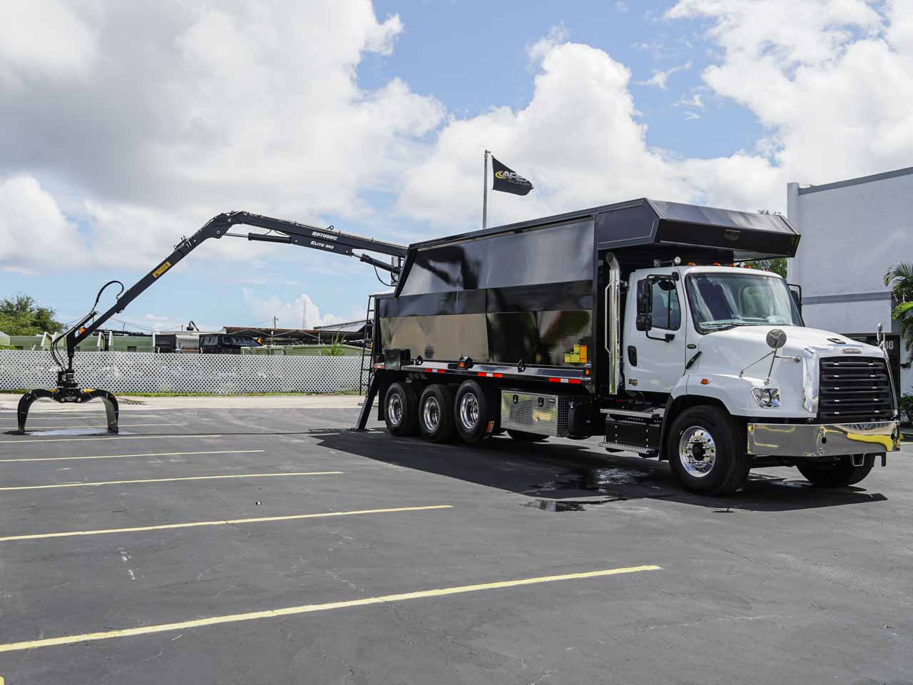 Heavy hydraulic grapple truck curbside waste pickup and bulk contractor hauling